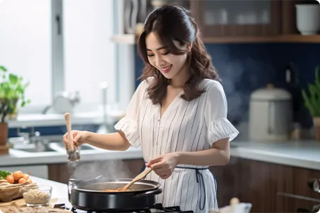 女性が料理をしている画像